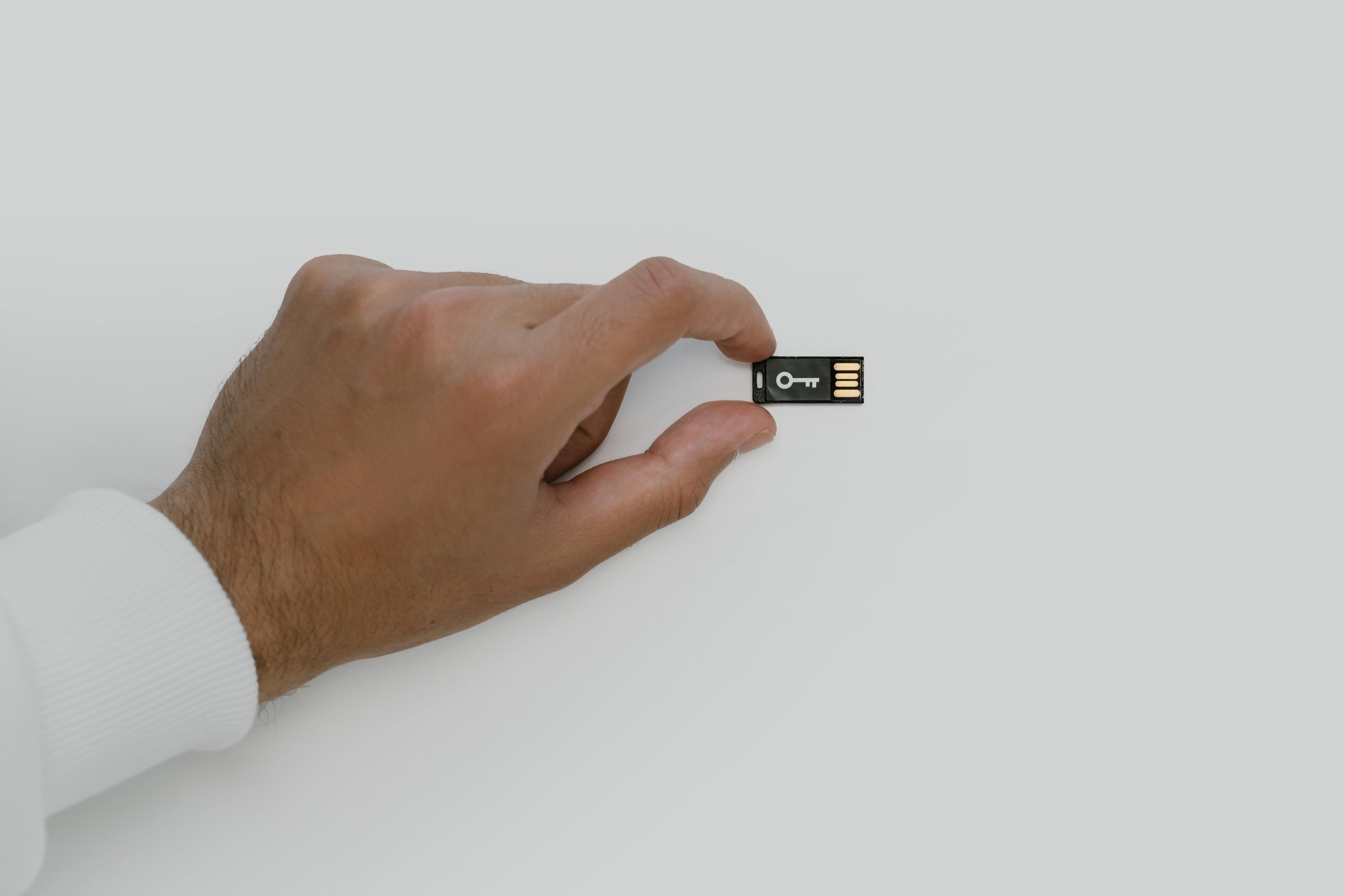Image of a hand holding a USB device